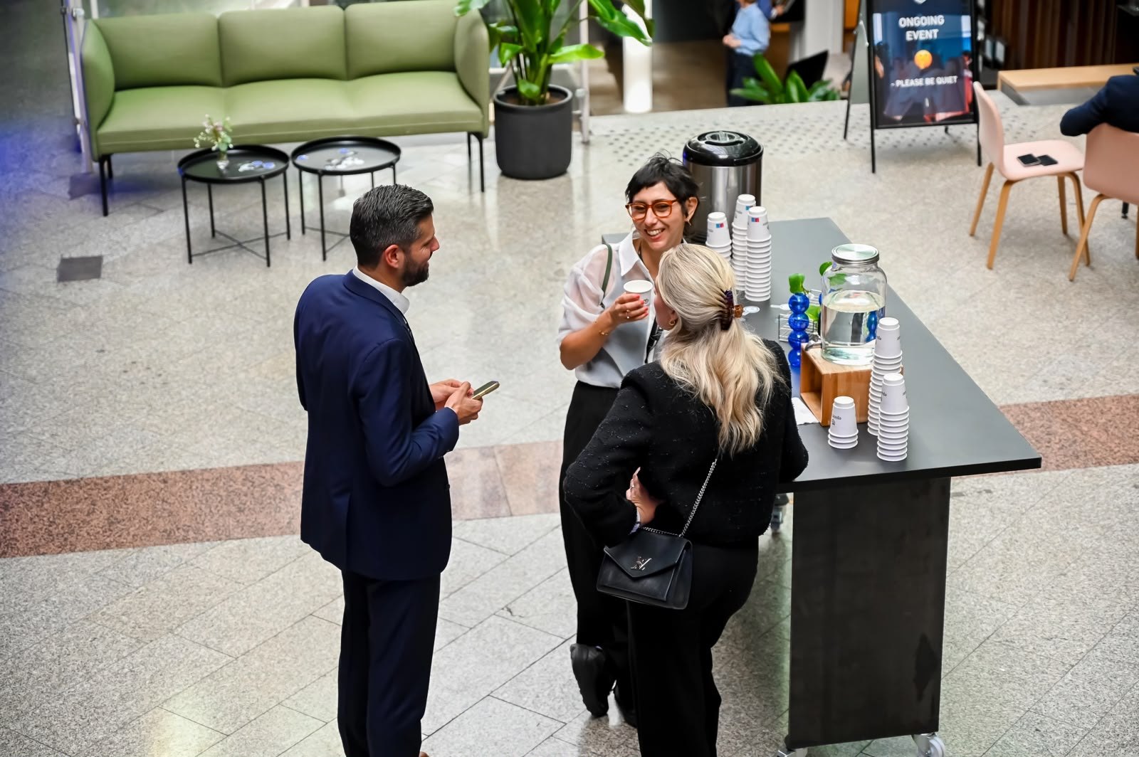 A quiet chat by the coffee station