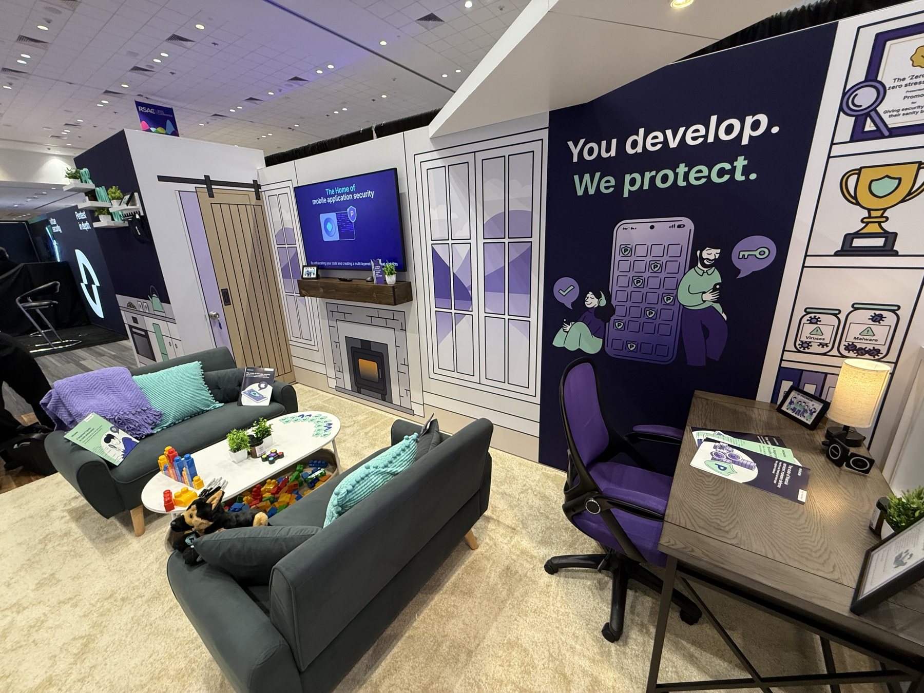The living room, with the 'You develop. We protect.' wall